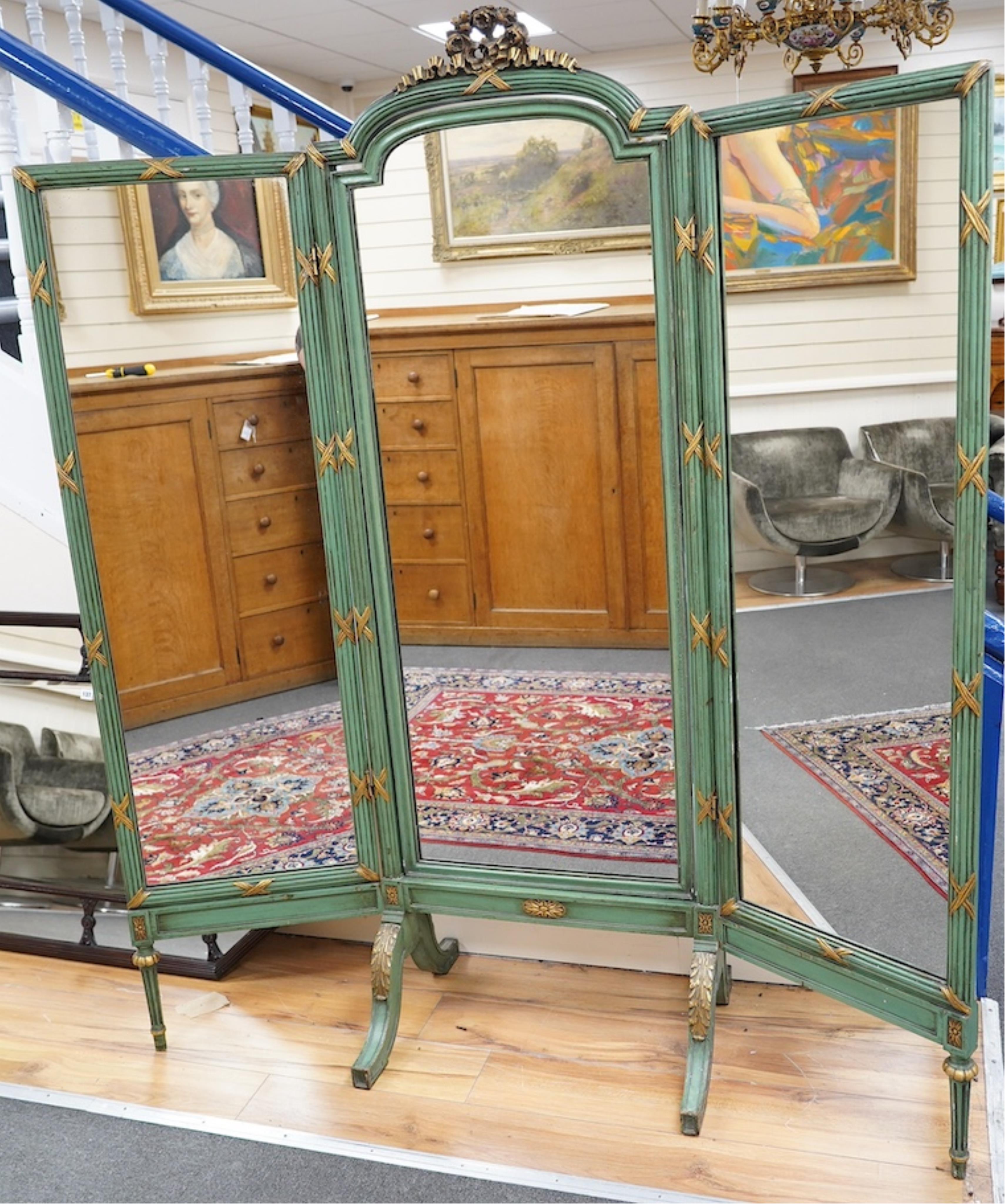 A Louis XVI style green painted and parcel gilt triple folding dressing mirror, width 160cm, height 185cm. Condition - fair